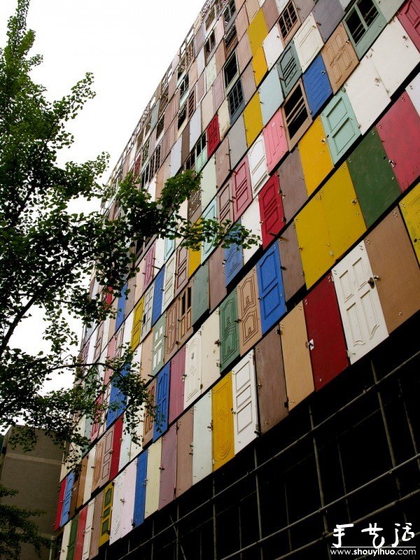 A building decorated with old doors