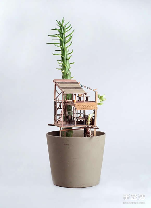 An exquisite Lilliputian-like miniature architectural treehouse model on a potted plant