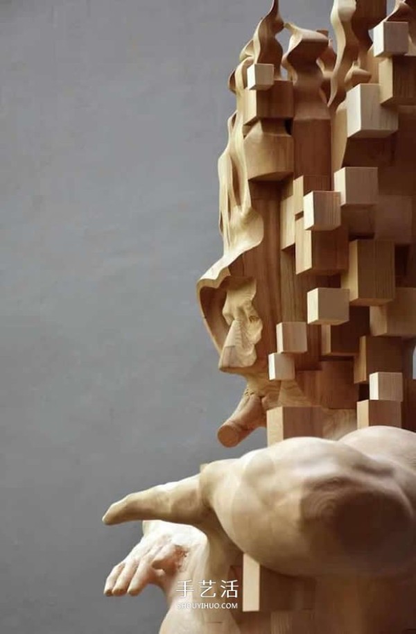 The wooden man is pixelated! The combination of traditional wood carving and digital elements