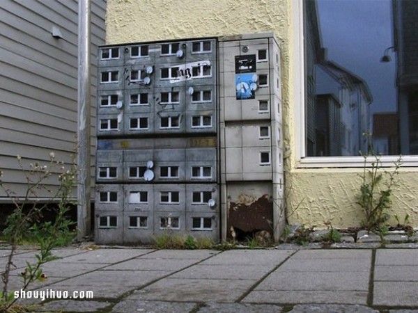 The cement piers and electrical boxes are transformed into houses with mini buildings and graffiti to beautify the environment