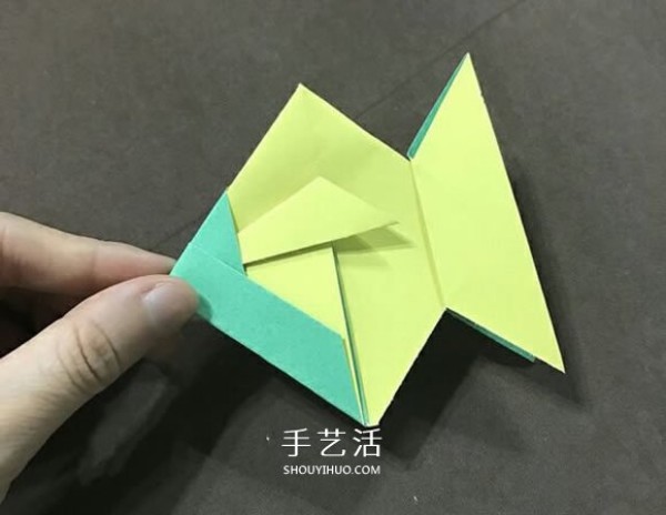 Illustration of how to fold a simple origami goldfish for children