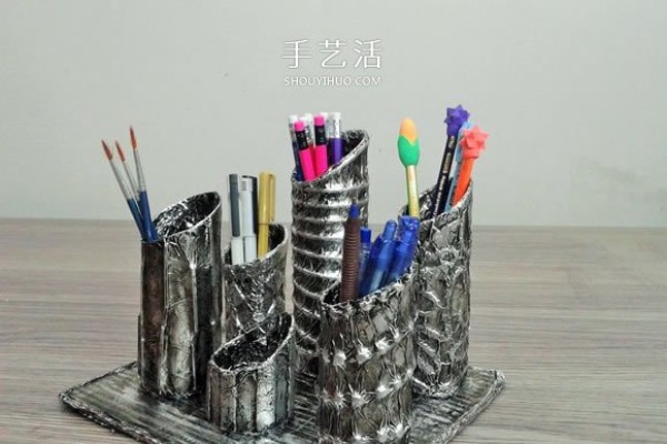 Handmade porous pen holders are made from waste paper rolls and cling film tubes