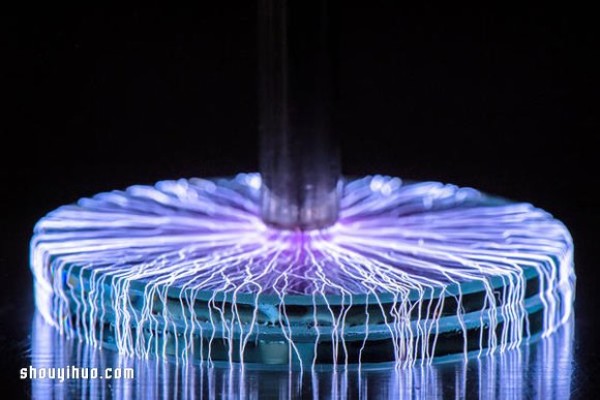 Photography of a perfect storm of artificial lightning under a Tesla coil