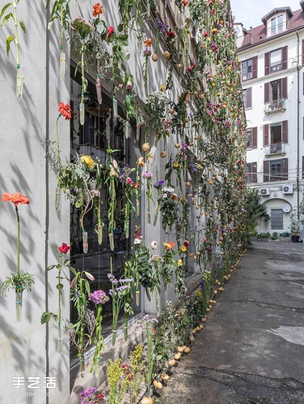 2,000 flowers are woven into a curtain for the spring facade of a Milan design studio