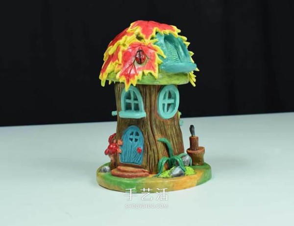 Handmade fairy house with paper clay and glass bottles