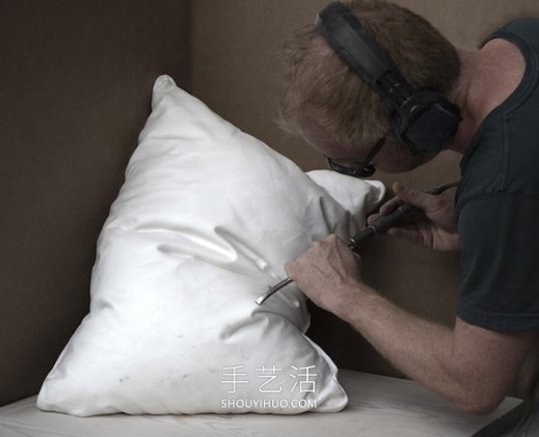 A marble block is carved into a white pillow with natural wrinkles! 