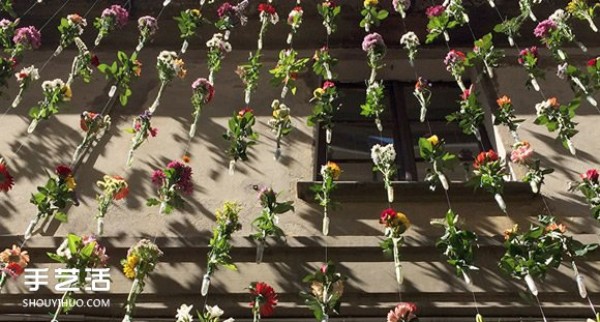 2,000 flowers are woven into a curtain for the spring facade of a Milan design studio