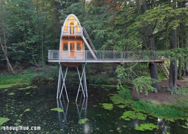 Old thatched hut transformed into a strange tree house standing in a lake