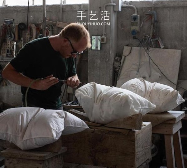 A marble block is carved into a white pillow with natural wrinkles! 