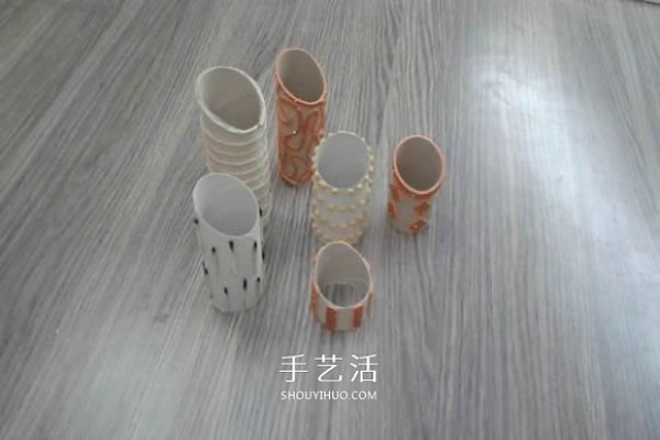 Handmade porous pen holders are made from waste paper rolls and cling film tubes