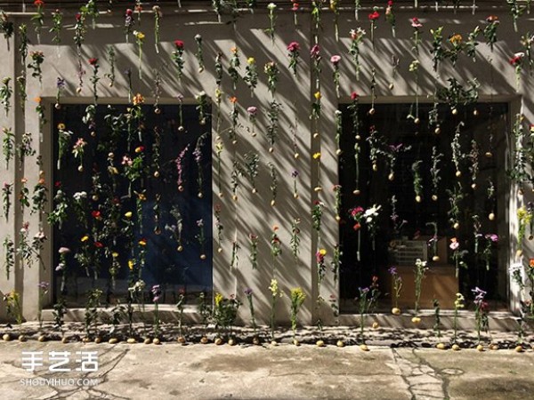 2,000 flowers are woven into a curtain for the spring facade of a Milan design studio