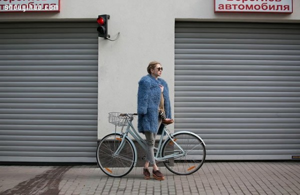 Moscows stylish bicycle girl walks elegantly in the urban area