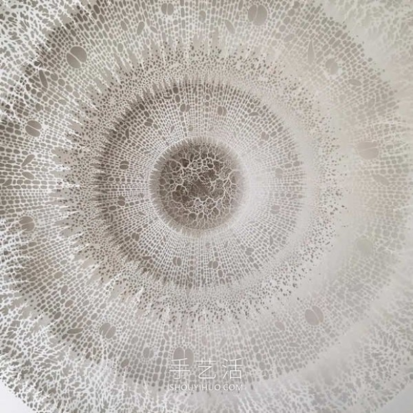 Intricate hand-cut paper sculptures that mimic microorganisms