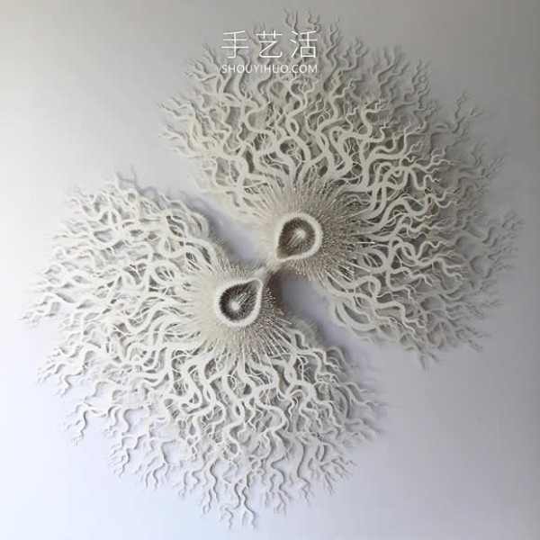 Intricate hand-cut paper sculptures that mimic microorganisms