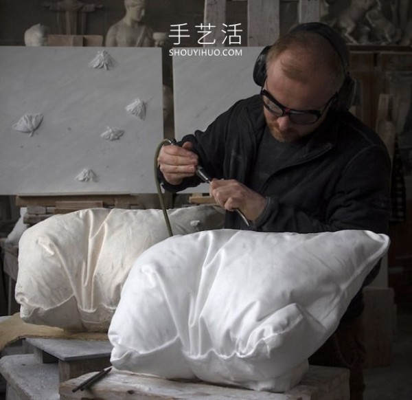 A marble block is carved into a white pillow with natural wrinkles! 