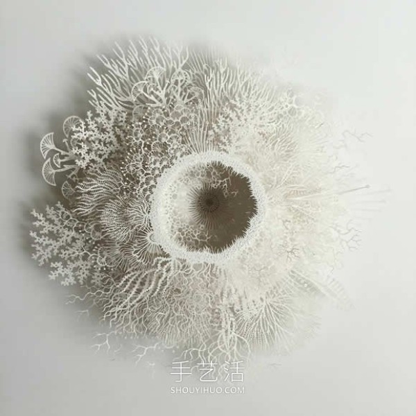 Intricate hand-cut paper sculptures that mimic microorganisms