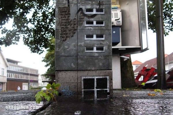 The cement piers and electrical boxes are transformed into houses with mini buildings and graffiti to beautify the environment