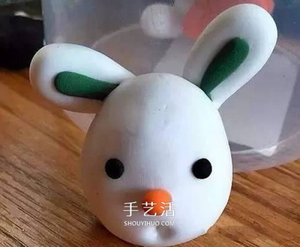 Handmade ultra-light clay handmade illustration of the little white rabbit holding a carrot