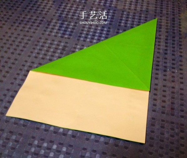 A detailed step-by-step illustration of a simple origami frog