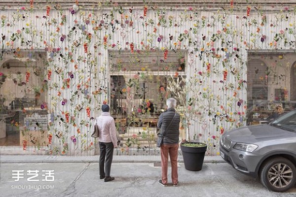 2000 flowers are woven into a curtain on the spring facade of a Milan design studio