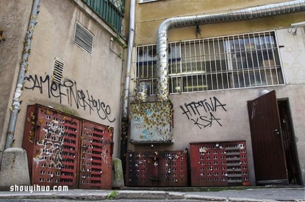 The cement piers and electrical boxes are transformed into houses with mini buildings and graffiti to beautify the environment