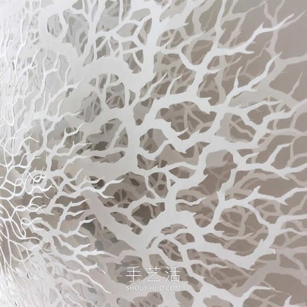 Intricate hand-cut paper sculptures that mimic microorganisms