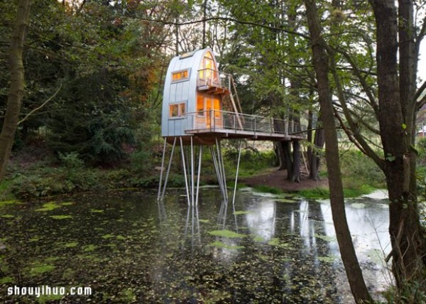 An old thatched hut transformed into a strange tree house standing in a lake