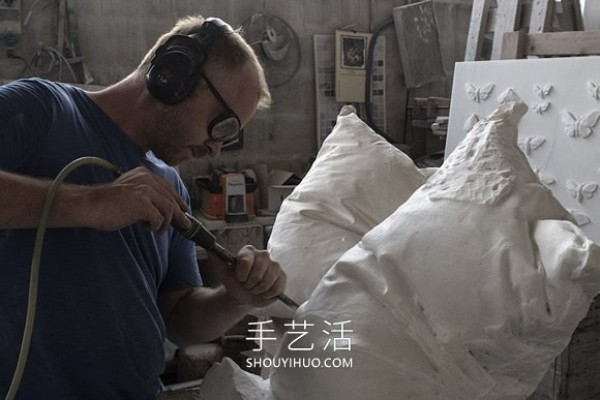 A marble block is carved into a white pillow with natural wrinkles! 