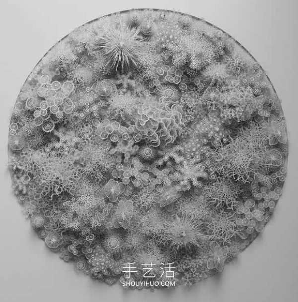 Intricate hand-cut paper sculptures that mimic microorganisms