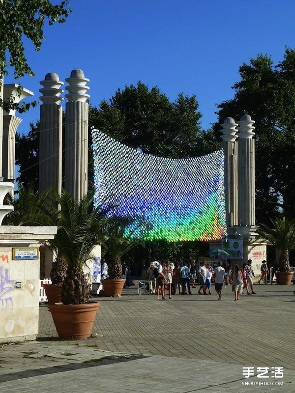 A giant rainbow curtain made of six thousand discarded CDs