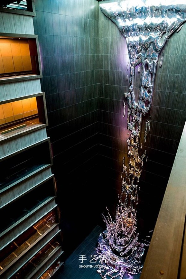 A 12-story metal waterfall sculpture pouring down