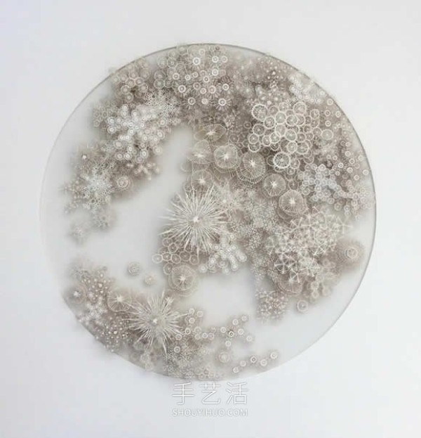 Intricate hand-cut paper sculptures that mimic microorganisms