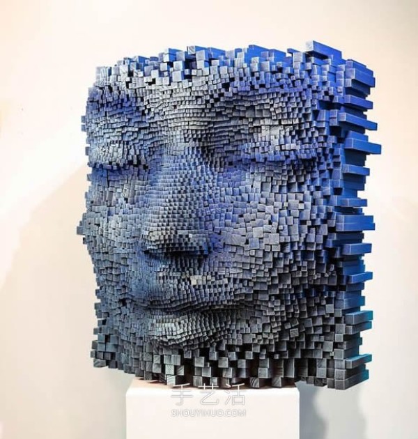 Vibrant pixelated wood carvings show the depth of the human soul