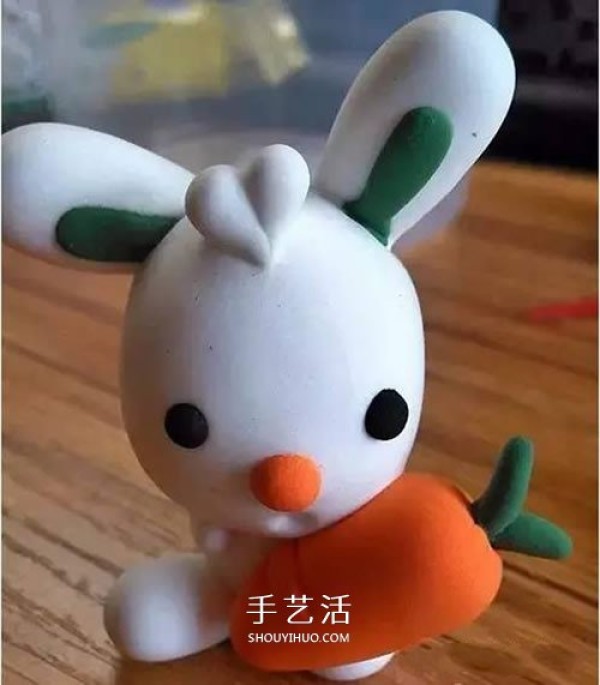 Handmade ultra-light clay handmade illustration of the little white rabbit holding a carrot