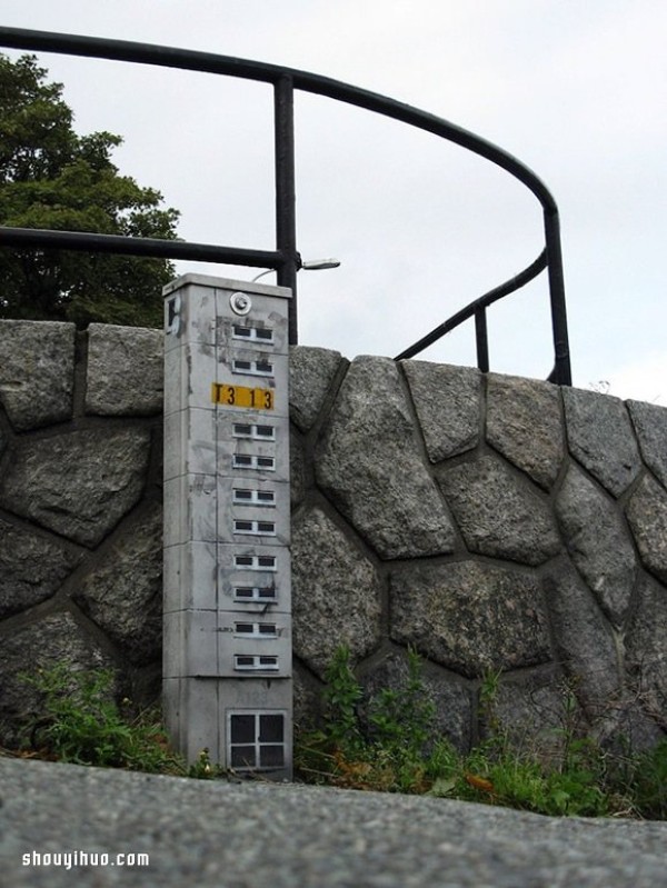 The cement piers and electrical boxes are transformed into houses with mini buildings and graffiti to beautify the environment