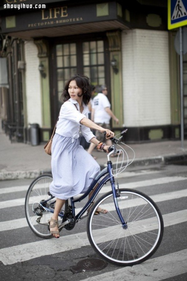 Moscows stylish bicycle girl travels elegantly in the urban area