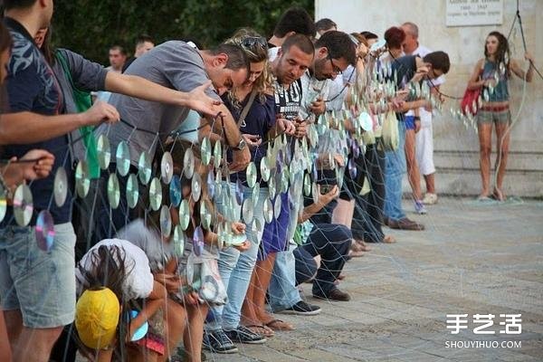 A giant rainbow curtain made of six thousand discarded CDs