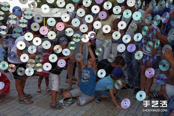 A giant rainbow curtain made of six thousand discarded CDs