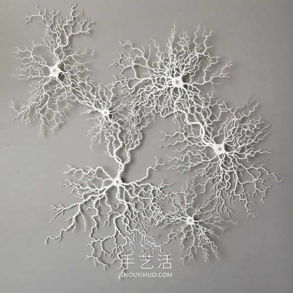 Intricate hand-cut paper sculptures that mimic microorganisms