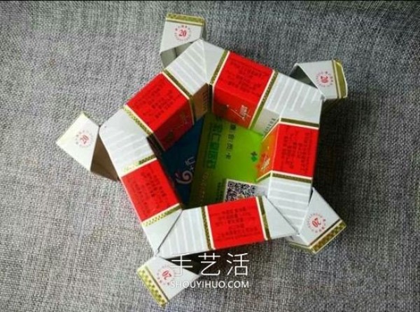 Empty cigarette box wastes are used to make handmade flower ashtrays/trash boxes