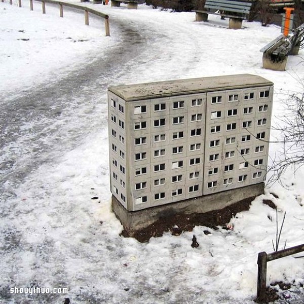 The cement piers and electrical boxes are transformed into houses with mini buildings and graffiti to beautify the environment