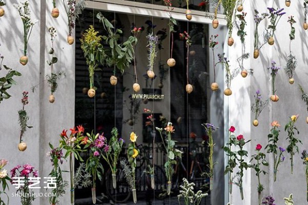 2,000 flowers are woven into a curtain for the spring facade of a Milan design studio