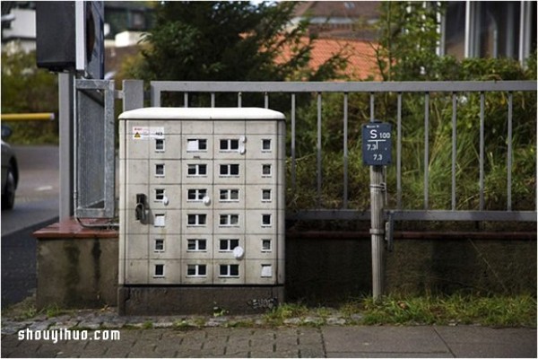 The cement piers and electrical boxes are transformed into houses with mini buildings and graffiti to beautify the environment