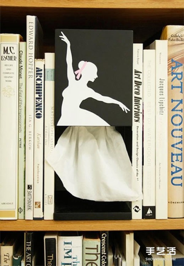 The elegant ballerina draws the paper out of the paper box and feels artistic when she holds it