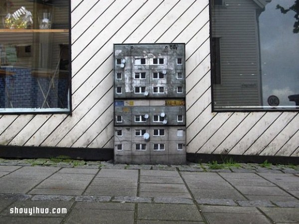 The cement piers and electrical boxes are transformed into houses with mini buildings and graffiti to beautify the environment