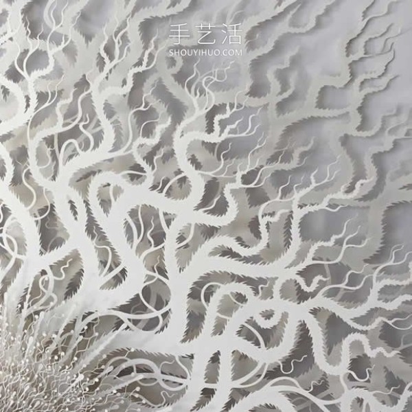 Intricate hand-cut paper sculptures that mimic microorganisms