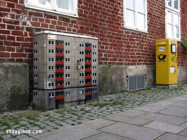 The cement piers and electrical boxes are transformed into houses with mini buildings and graffiti to beautify the environment