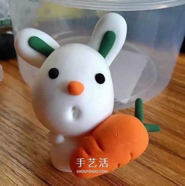 Handmade ultra-light clay handmade illustration of the little white rabbit holding a carrot