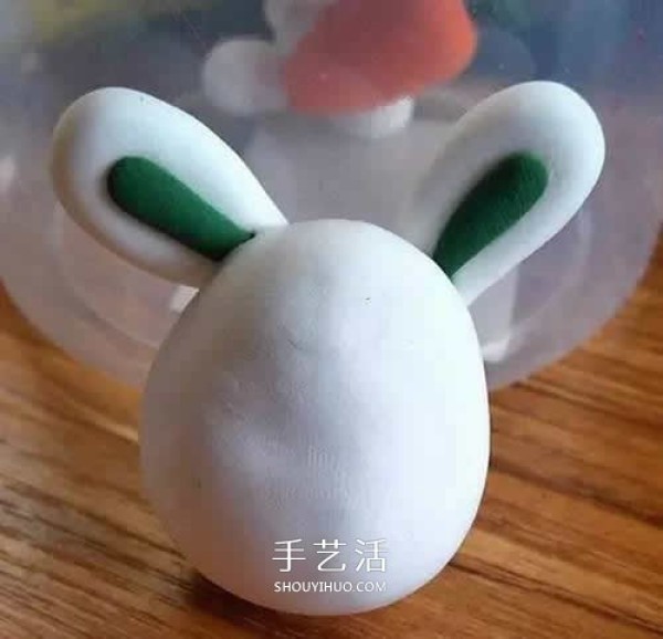 Handmade ultra-light clay handmade illustration of the little white rabbit holding a carrot