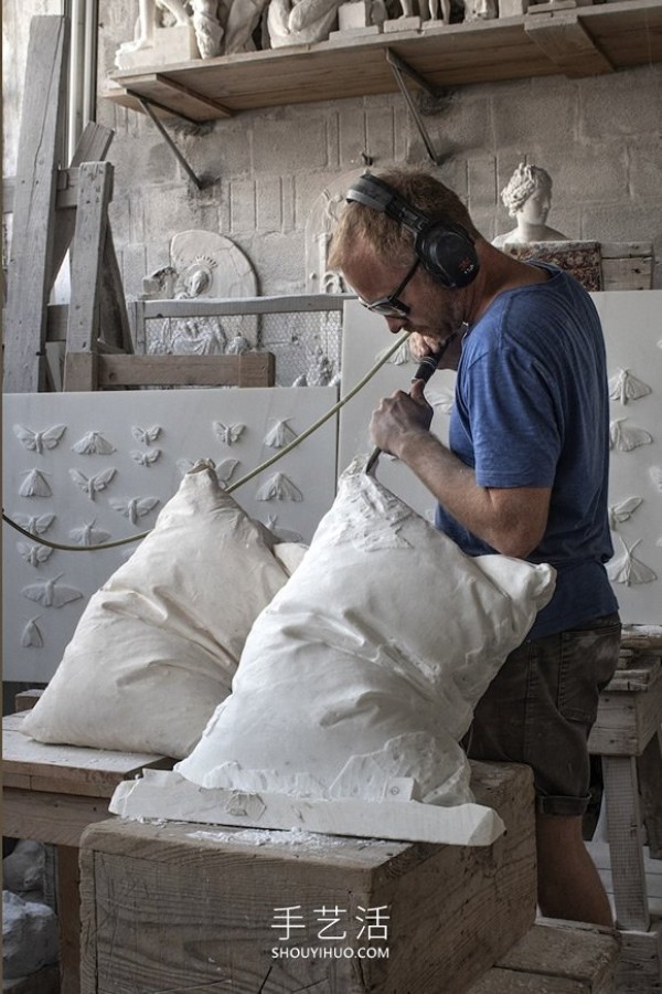 A marble block is carved into a white pillow with natural wrinkles! 